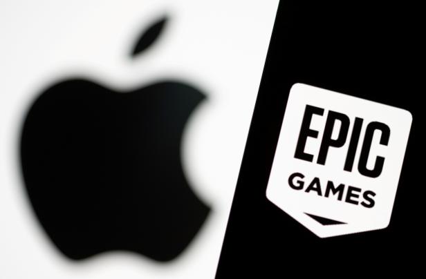 FILE PHOTO: Smartphone with Epic Games logo is seen in front of Apple logo in this illustration