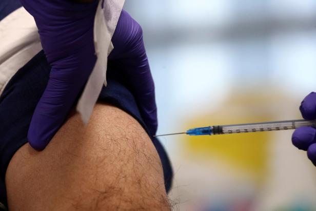 FILE PHOTO: A man receives his dose of the Comirnaty Pfizer-BioNTech COVID-19 vaccine in Madrid