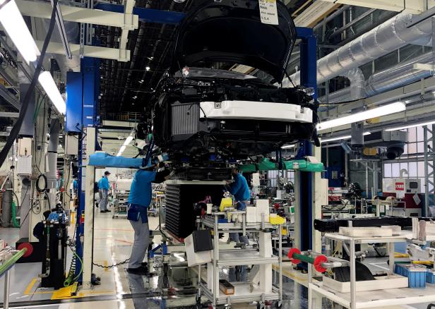 FILE PHOTO: Workers install the fuel cell power system in a Toyota Mirai at a Toyota Motor Corp. factory in Toyota