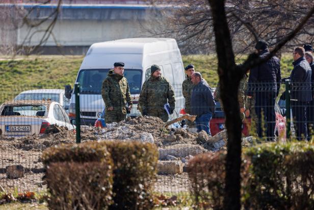 Police and military officers stand at a drone crash site, following Russia's invasion of Ukraine, in Zagreb