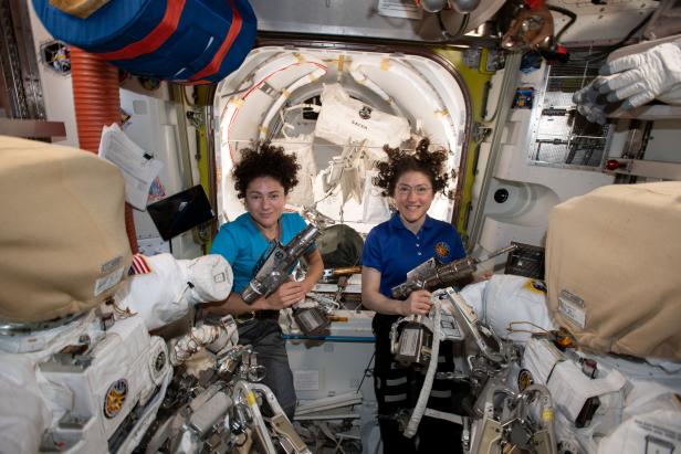 U.S. astronauts Jessica Meir and Christina Koch pose in the International Space Station