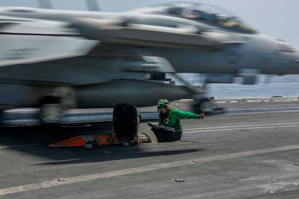 Aviation Boatswain's Mate operates a catapult as an EA-18G Growler of Electronic Attack Squadron (VAQ) 140 is launched off the flight deck of U.S. Navy's aircraft carrier USS Abraham Lincoln in the Gulf