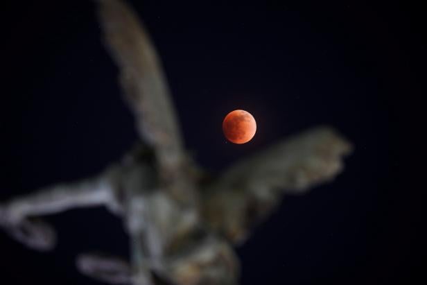 A full moon moves through the shadow of the earth during a "Blood Moon" lunar eclipse in San Salvador