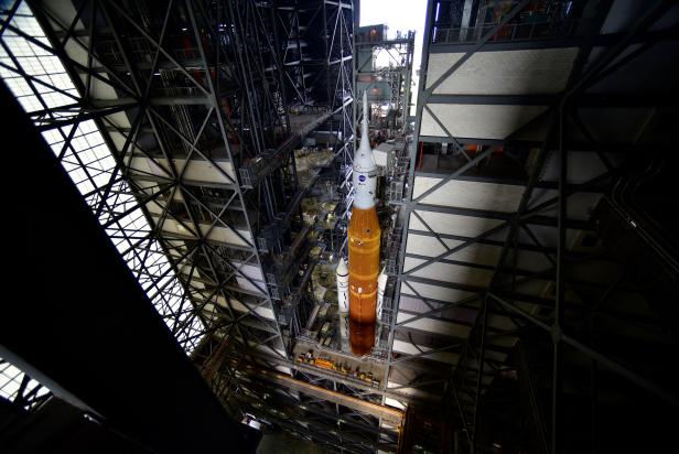 NASA's next-generation moon rocket, the Space Launch System rocket with its Orion crew capsule perched on top, leaves the Vehicle Assembly Building