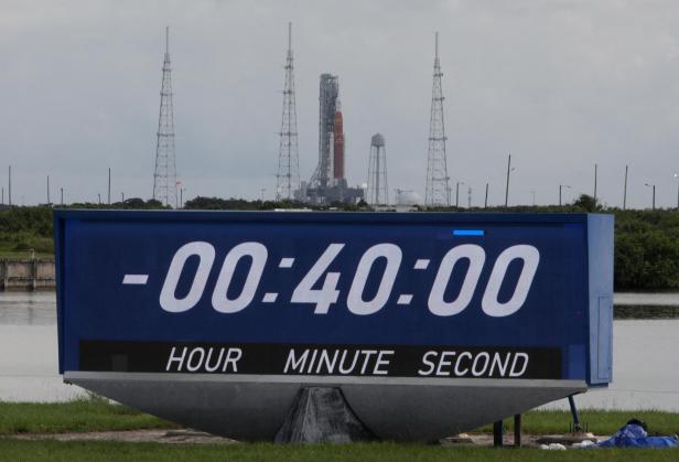 NASAs next-generation moon rocket, the Space Launch System (SLS) rocket is shown above the press site countdown clock after launch was delayed