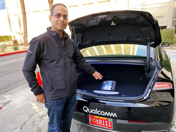 Dheeraj Ahuja, Senior Director Of Engineering at Qualcomm, shows the new Snapdragon Ride autonomous driving computing system in the trunk of a demo car at the Consumer Electronics Show in Las Vegas