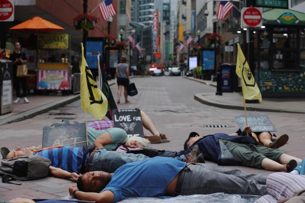 Environmental activists hold a die-in in Boston