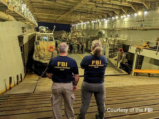 FBI agents process the remains of a balloon shot down by U.S. military off South Carolina