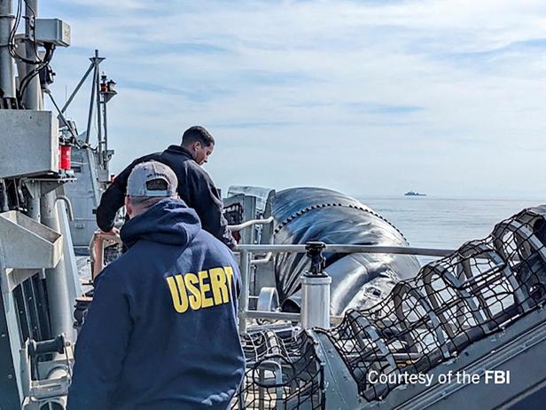 FBI agents process the remains of a balloon shot down by U.S. military off South Carolina