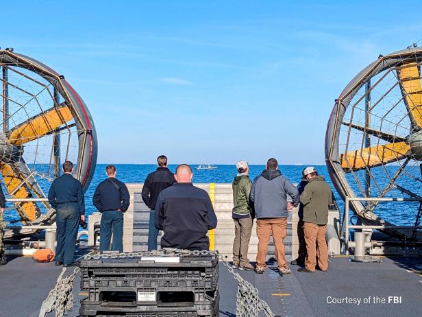 FBI agents process the remains of a balloon shot down by U.S. military off South Carolina