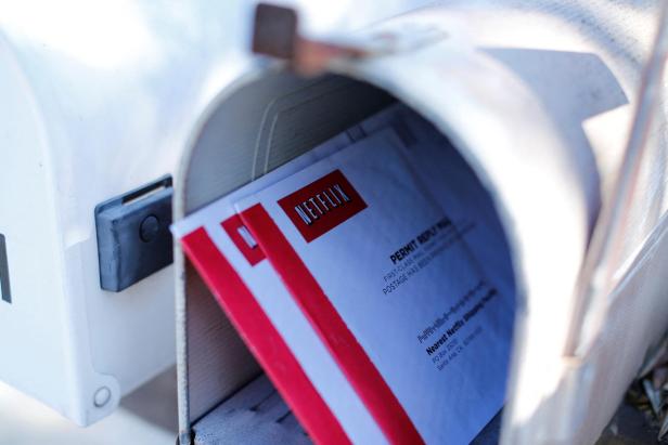 FILE PHOTO: Netflix DVD return mailers are shown in a mail box in Encinitas' California