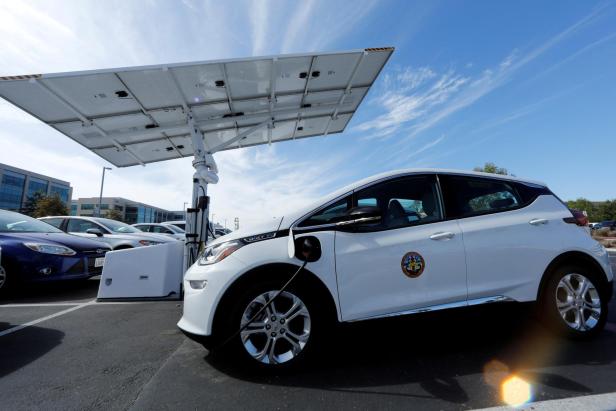 FILE PHOTO: A small fleet of electric Chevrolet Bolt vehicles are charged by a sun tracking  solar panel car charing system in San Diego,