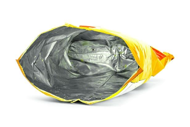 Potato chips bag isolated on white background. Inside of leftovers snack packaging.