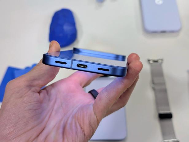 Ein blaues Google Pixel Smartphone wird in der Hand gehalten.