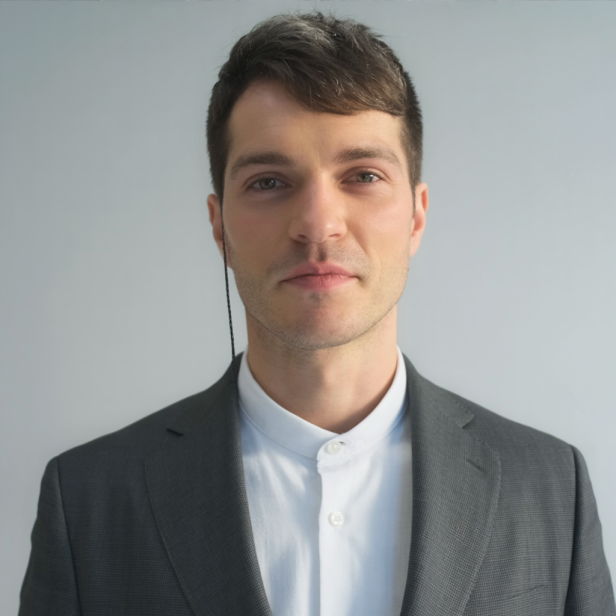 Ein Mann mit Anzug und Knopf-Halsband trägt ein KI-gestütztes Gerät.