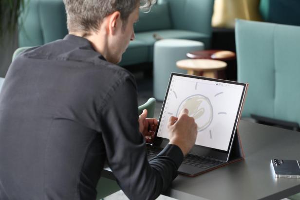 Ein Mann malt eine Sonne auf einem Boox Tab X C.