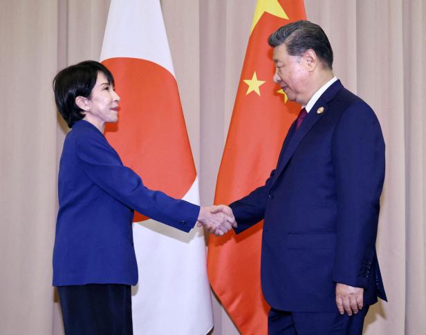 Japanese Prime Minister Sanae Takaichi shakes hands with Chinese President Xi Jinping ahead of their talks in Gyeongju, South Korea