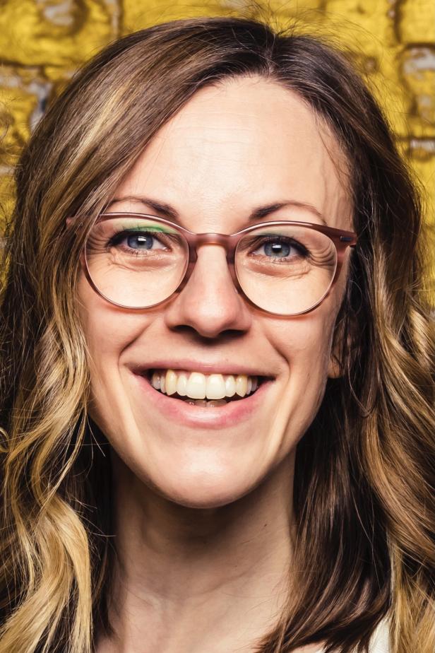 eine dunkelblonde Frau mit Brille