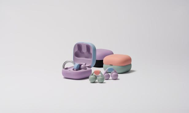 Sony LinkBuds Clip und ihre Ladecases in pastelligen Farben, mit offenem und geschlossenem Case sowie zwei Paar Kopfhörern im Vordergrund.