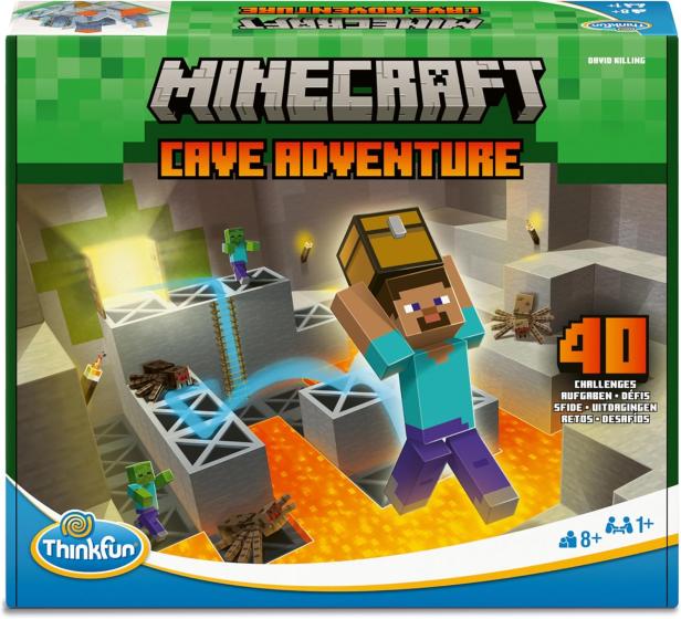 Die Verpackung des Spiels „Minecraft Cave Adventure“ von Ravensburger zeigt eine Spielfigur, die eine Schatztruhe über Lava trägt, umgeben von Zombies und Spinnen.