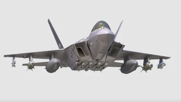Ein grauer Kampfjet mit voller Bewaffnung