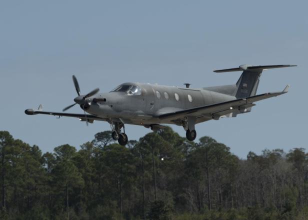 Graues Propellerflugzeug setzt zur Landung an