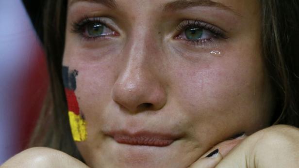 A Germany soccer fan cries after Italy won the Euro 2012 semi-final soccer match against Germany at the National stadium in Warsaw, June 28, 2012. REUTERS/Peter Andrews (POLAND - Tags: SPORT SOCCER TPX IMAGES OF THE DAY)
