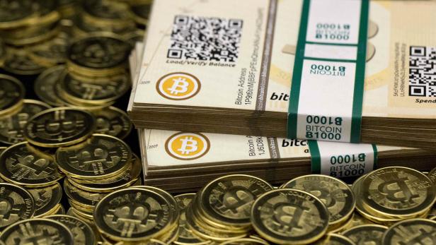 Some of Bitcoin enthusiast Mike Caldwell's coins and paper vouchers often called "paper wallets" are pictured at his office in Sandy, Utah