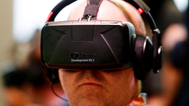 FILE PHOTO - Attendee tries Oculus Rift Development Kit 2 headset at Electronic Entertainment Expo in Los Angeles