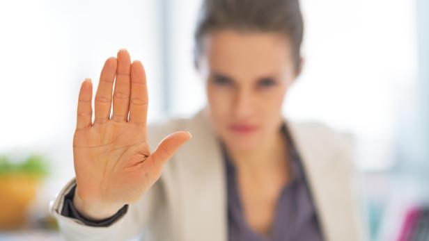 closeup on business woman in office showing stop gesture