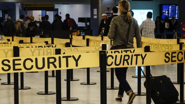 Passengers make their way in a security checkpoint at the International JFK airport in New York