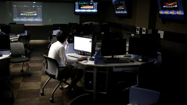 A student sits in front of a computer while demonstrating softwares during an interview with Reuters at War Room at The Korea University in Seoul