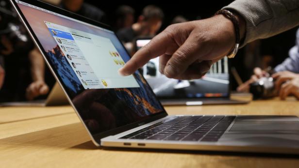 A guest points to a new MacBook Pro during an Apple media event in Cupertino