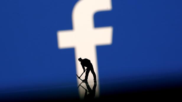 FILE PHOTO: A figurine is seen in front of the Facebook logo in this illustration