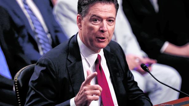 FILE PHOTO: Former FBI Director Comey testifies before a Senate Intelligence Committee hearing in Washington
