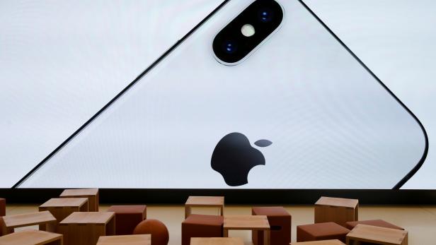 FILE PHOTO: An iPhone X is seen on a large video screen in the new Apple visitor centre in Cupertino