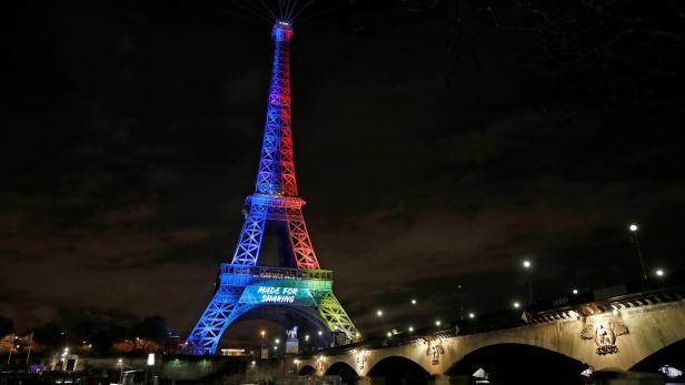 Eiffel Tower is lit in the colours of the Olympic flag during the launch of the international campaign for the Paris bid to host the 2024 Olympic Games