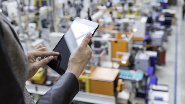 Female manager working on tablet in factory