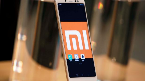 A company logo of Xiaomi is displayed on its smartphone in Hong Kong