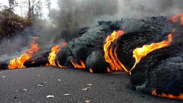 A lava flow is seen on a road in Pahoa