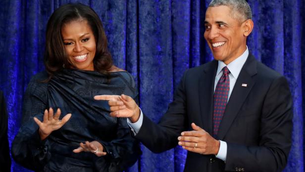 FILE PHOTO: Former U.S. President Obama and first lady Michelle Obama acknowledge guests during  portraits unveiling at the Smithsonians National Portrait Gallery in Washington