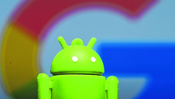 A 3D printed Android mascot Bugdroid is seen in front of a Google logo in this illustration