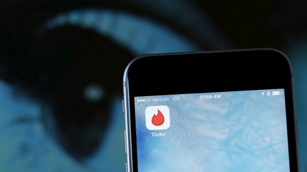 FILE PHOTO: Photo illustration of dating app Tinder shown on an Apple iPhone