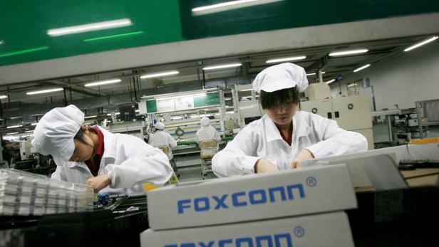 File photo of employees working inside a Foxconn factory in the township of Longhua, China