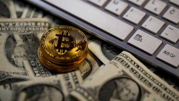 FILE PHOTO: Bitcoin (virtual currency) coins placed on Dollar banknotes are seen in this illustration picture