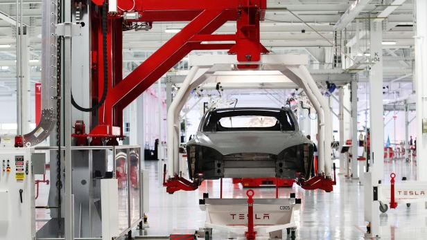 FILE PHOTO --  The body of a Tesla Model S is lifted by an automated crane at the Tesla factory in Fremont