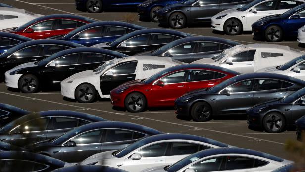 Rows of new Tesla Model 3 electric vehicles are seen in Richmond, California.