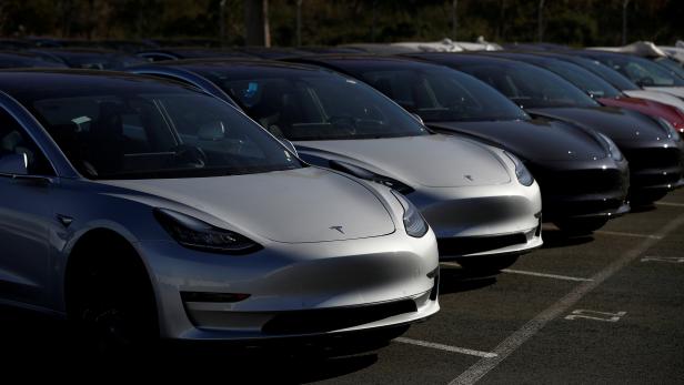 FILE PHOTO: A row of new Tesla Model 3 electric vehicles is seen at a parking lot in Richmond California