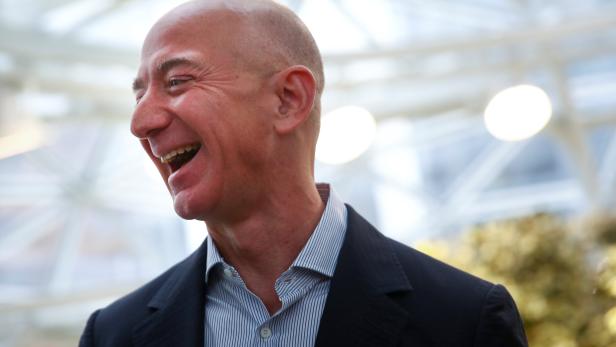 Amazon founder and CEO Jeff Bezos laughs as he talks to the media while touring the new Amazon Spheres during the grand opening in Seattle