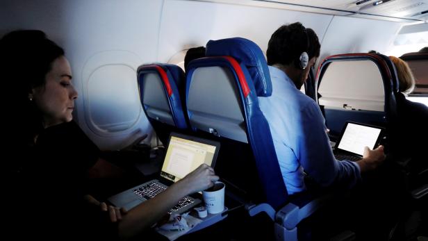 FILE PHOTO --  Passengers use their laptops on a flight out of JFK International Airport in New York